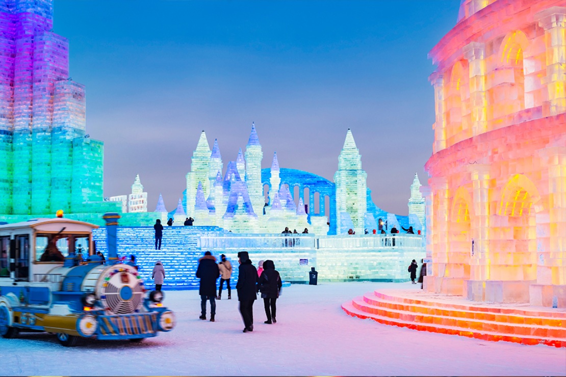 : Ice and Snow World in Harbin, China lighting up during the blue hour